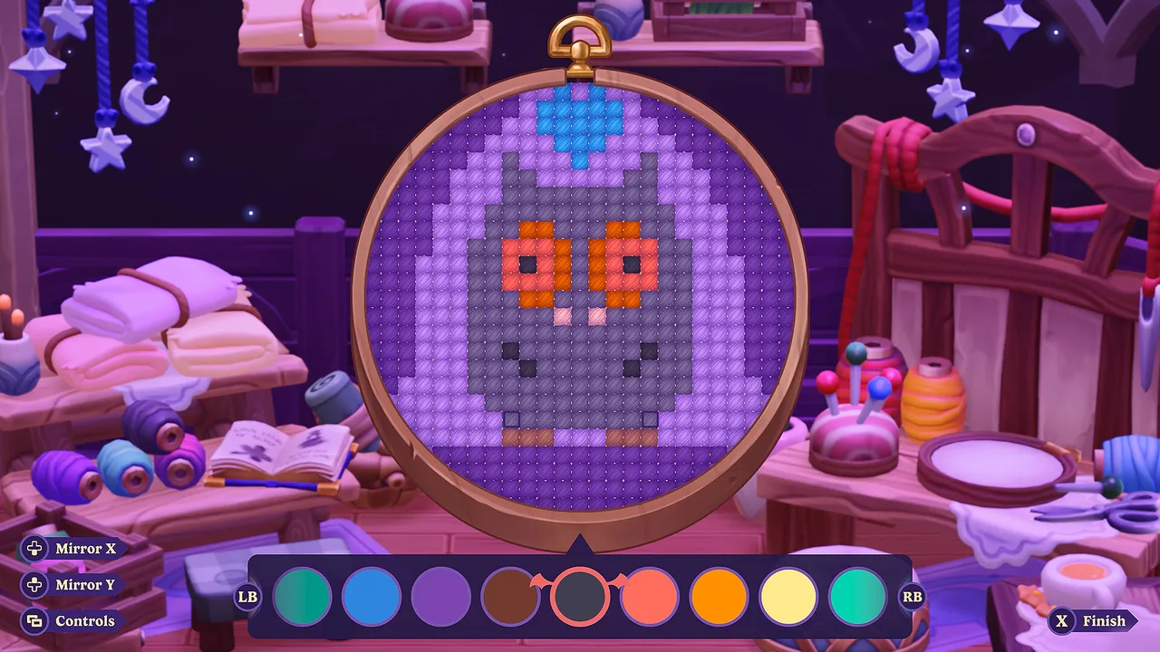 The embroidery hoop in Moonlight Peaks with a cross-stitch pattern in progress and a colour palette below.