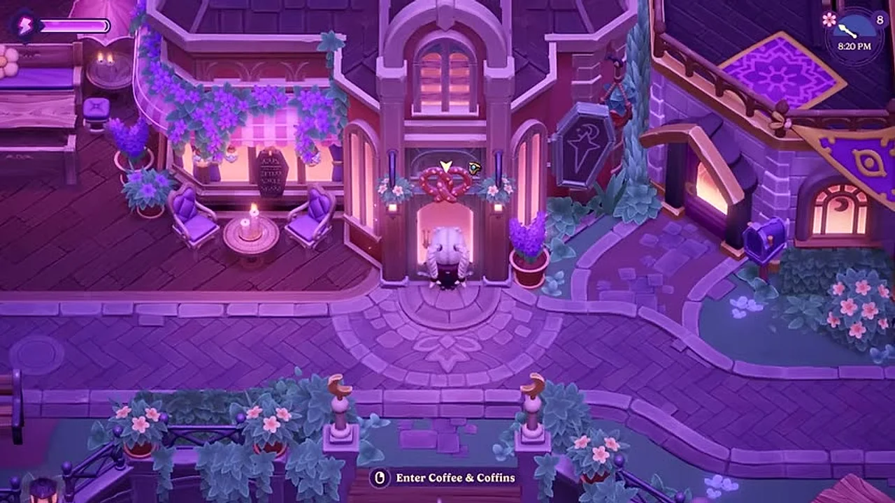 The player standing outside the Coffee & Coffins café at night in the town centre of Moonlight Peaks, lit by lanterns and candlelight.